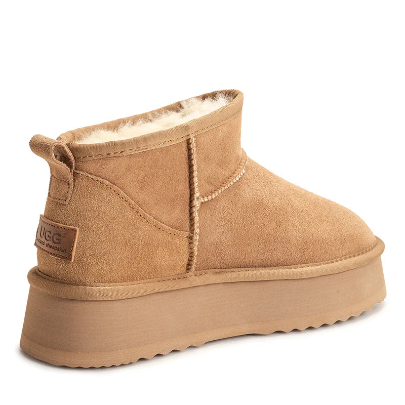 Auzland Ultra Mini Platform UGG Boots in beige, showing the ankle-high design with plush sheepskin lining and rugged rubber sole.