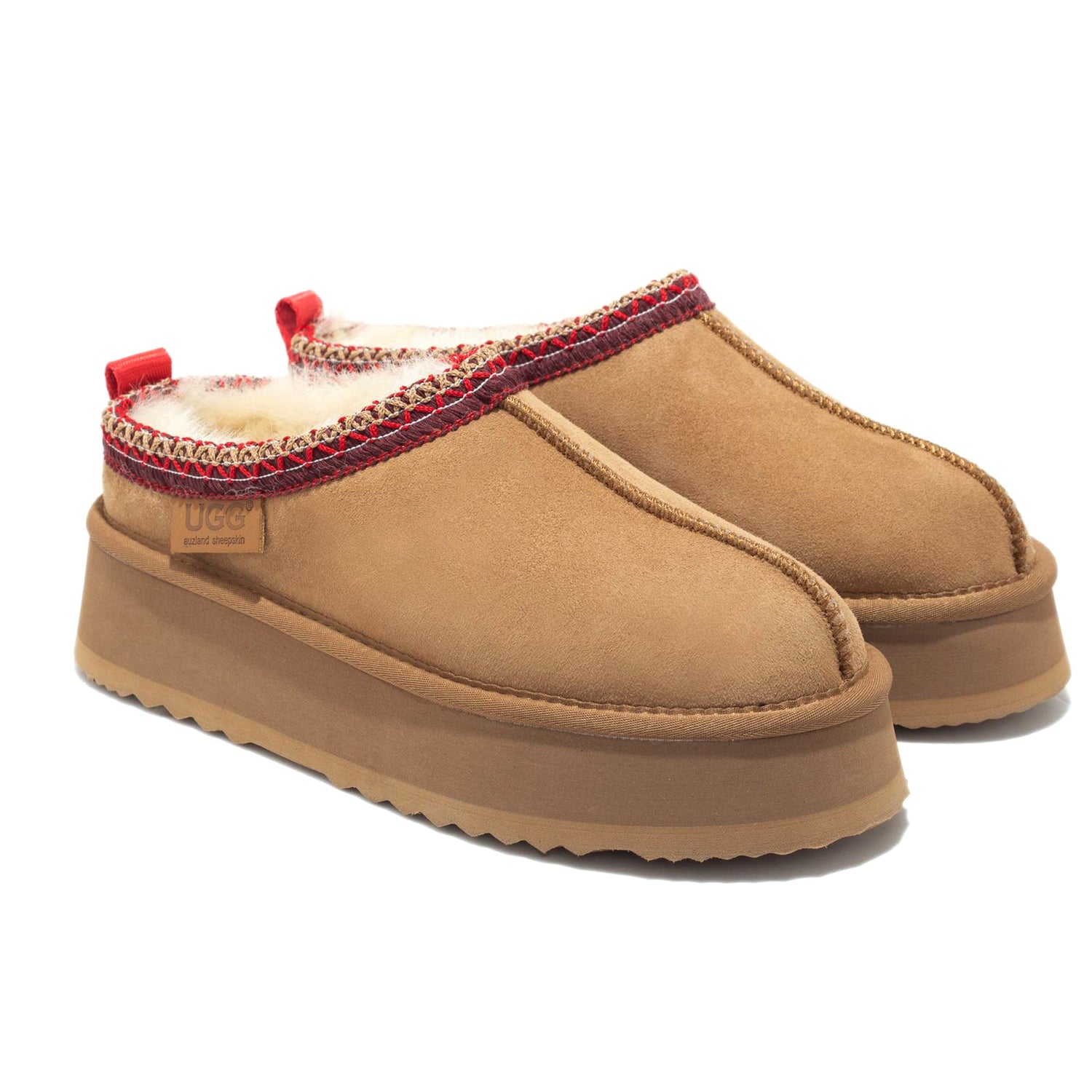 Auzland Mackenzie Platform UGG slippers with plush lining and thick sole, displayed on a chest surface.