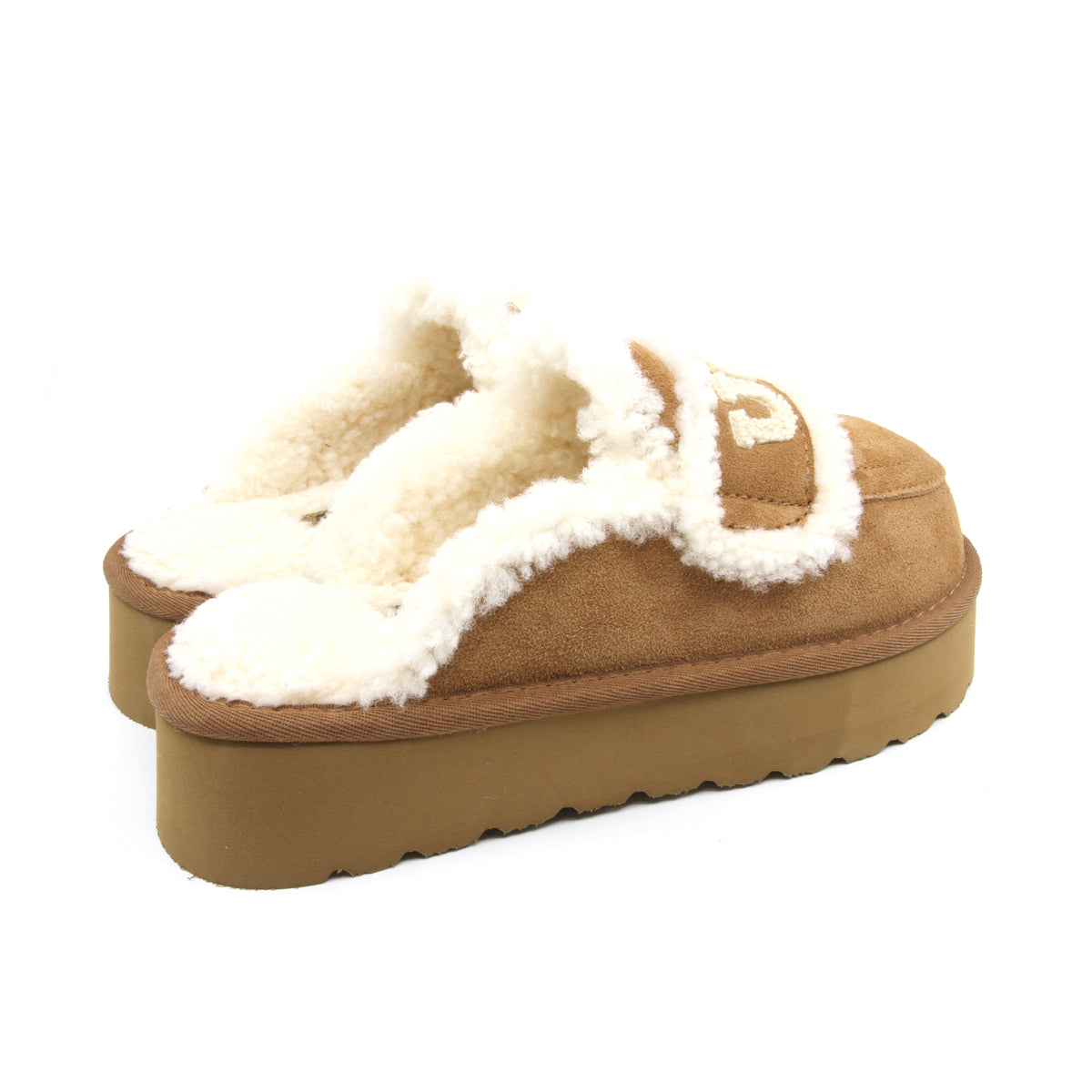 Auzland UGG shearling platform slippers in chestnut, showing soft shearling lining and sturdy sole for cosy indoor wear.