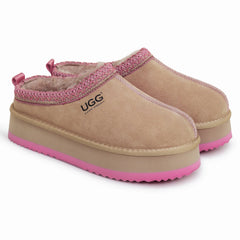 Auzland Mackenzie platform UGG slippers with plush lining and tan leather exterior, displayed on a neutral background.
