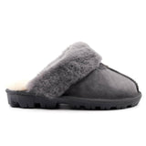 A pair of grey UGG Scuff Slippers for women and men, featuring soft plush material and slip-on design from Auzland.